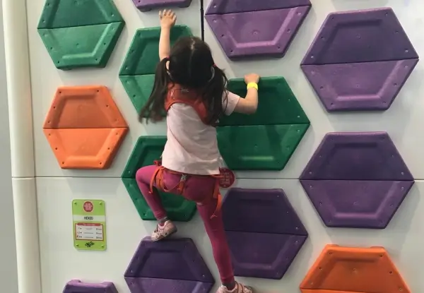 Young girl climbing clip n climb wall at Andover Leisure Centre