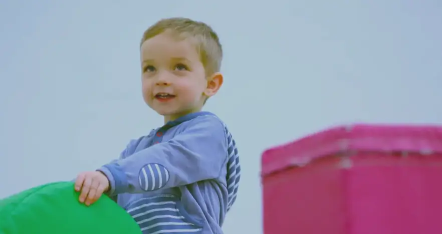 Child playing with soft play equipment