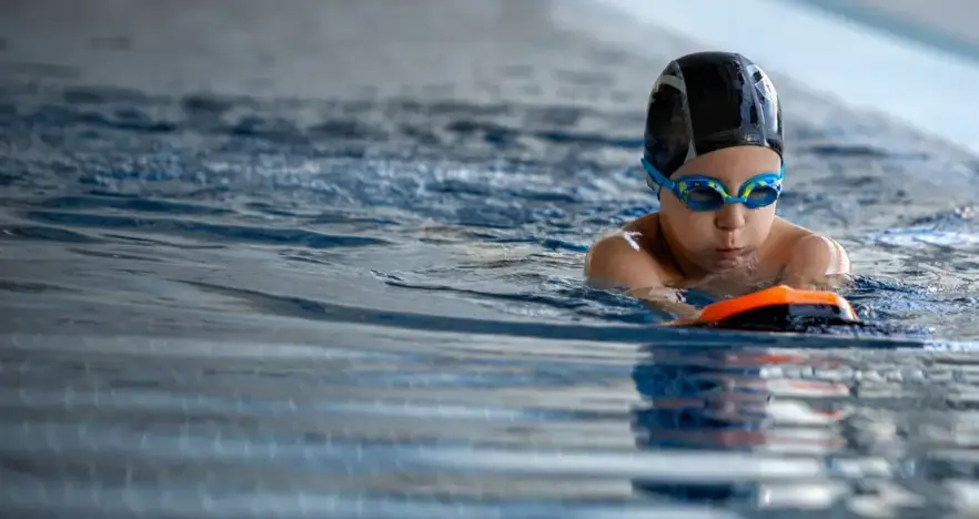 Child swimming with a float